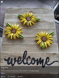 three sunflowers are placed on a welcome sign