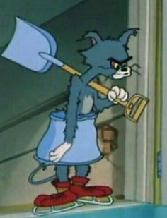 the blue cat is holding a broom and looking at something in front of her face