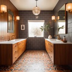 a large bathroom with two sinks, mirrors and lights on the wall above it is tiled flooring