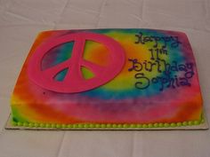 a peace sign birthday cake on a table