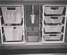 an organized pantry with bins, baskets and other items in black and white photo