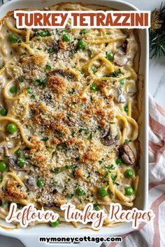 turkey tetrazzini in a white casserole dish with green peas and parmesan cheese