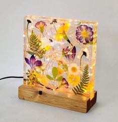 a light that has flowers on it and lights in the shape of an acrylic sheet