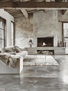 a living room with a couch, fireplace and large windows in black and white photo