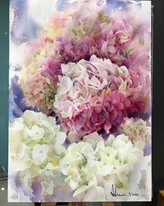 an easel with a painting of pink and white flowers on it