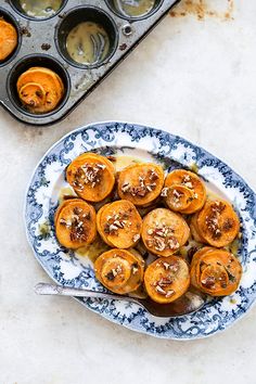 a bowl filled with food next to muffin tins on top of a table