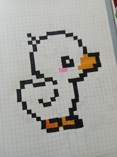 an image of a duck drawn in pixel style on graph paper with marker pens and markers