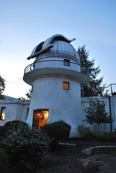 a white building with a large dome on it's roof and stairs leading up to the entrance