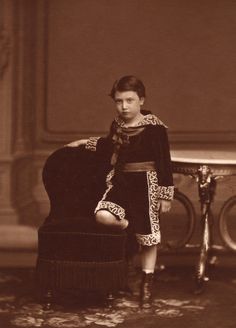 an old photo of a woman sitting on a chair