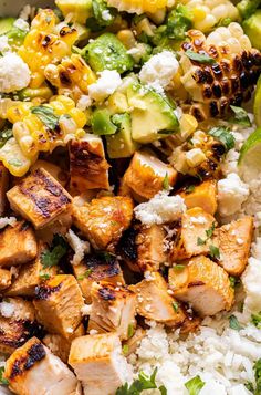 a white bowl filled with chicken, rice and avocado