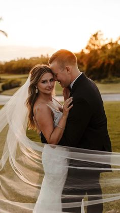 a bride and groom pose for their wedding photo