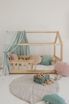 a child's room with a bed, toys and other items on the floor