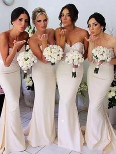 the bridesmaids are all dressed in white dresses