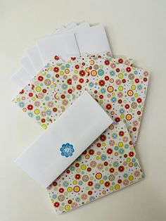 several envelopes with flower designs on them