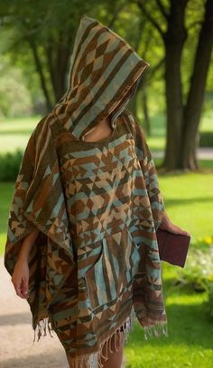 Wooden poncho, that keeps you warm: This unique poncho combines the warmth of traditional wool with the structure and natural aesthetics of wood fibers. Very Comfortable: Designed for ultimate comfort, it blends softness and flexibility, ensuring a cozy and pleasant wearing experience. Tribal look: The poncho features intricate tribal patterns and designs, giving it an authentic, culturally rich appearance. Can be used as a mat/sheet in parks for picnic: Its durable and versatile construction al Cozy Brown Poncho For Outdoor, Brown Long Sleeve Poncho For Outdoor, Cozy Brown Hooded Poncho, Oversized Cozy Poncho For Outdoor, Oversized Brown Poncho Cape, Oversized Bohemian Poncho For Outdoor, Poncho Men, Poncho Women, Natural Aesthetics