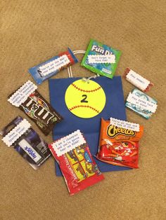 a bag with candy, candies and sports balls on it sitting on the floor