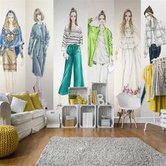 a living room filled with lots of furniture and wallpaper covered in colorful fashion illustrations