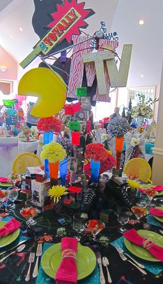 the table is set up for a party with colorful plates and napkins on it