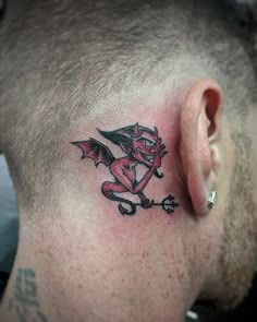 a man with a dragon tattoo on his neck and behind the ear is an arrow