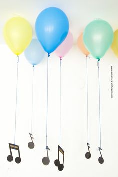 five balloons with musical notes attached to them