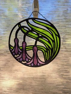 a stained glass window hanging from a chain