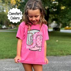 You will love this Christian t-shirt for girls. It is based on the Bible verse 2 Corinthians 5:7. It says, walking by faith not by sight.  There is an adorable retro cowgirl boot graphic on the front of the tee to go along with the scripture. Share your faith in Jesus with others through your apparel. These comfort colors brand tees are so soft and comfortable for children and adults. Find the adult version of this shirt here: https://www.etsy.com/listing/1750337961/christian-western-shirt-for-women -100% combed ringspun cotton -Medium fabric (6.1 oz/yd² (206.8 g/m -Classic Fit -Sew-in twill label T shirt Care instructions: Machine wash: cold (max 30C or 90F); Do not bleach; Tumble dry: low heat; Iron, steam or dry: low heat; Do not dryclean. Fit & Sizing: Please lay one of your shirts at Pink Slogan T-shirt For School, Casual Pink T-shirt For School, Christian Cowgirl, Christian Kids Shirts, Christian Concert, Retro Cowgirl, Jesus Tees, Cowgirl Boot, Christian Kids