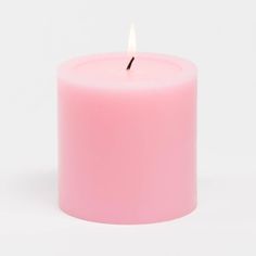 a pink candle is lit on a white background