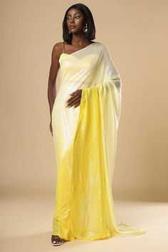 Introducing a traditional One Minute Saree in Yellow and white color with a modern twist of shimmer fabric. It is paired with a Yellow Satin blouse. Style this fabulously for traditional occasions as well as cocktail occasions. Product Features:  Saree Type : Ready to wear, Pre-stitched, Pre-draped Saree Saree Color: Yellow and white Blouse Color: Yellow Saree Fabric: Georgette Sequins Blouse Fabric: Satin Work: Shimmer Shoulder Drape:  Customer must select the shoulder drape style while orderin Diwali Party Pre-draped Tissue Silk Saree, Glamorous Festive Pre-draped Saree For Celebration, Glamorous Tissue Silk Saree With Zari Work, Fitted Glamorous Dupatta For Festive Occasions, Glamorous Silk Saree With Sheer Dupatta, Fitted Glamorous Dupatta With Traditional Drape, Glamorous Tissue Silk Saree For Festive Occasions, Festive Evening Raw Silk Saree, Elegant Traditional Wear With Traditional Drape For Evening