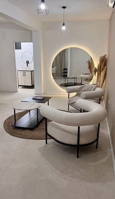 a living room filled with furniture and a round mirror