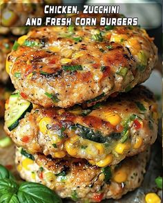 three burgers stacked on top of each other with the title chicken, zucchini and fresh corn burgers