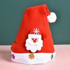 a santa claus hat on a pink table