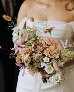 a bride holding a bouquet of flowers in her hands