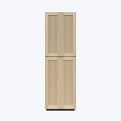 a tall wooden cabinet sitting on top of a white wall