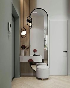 a white chair sitting in front of a mirror on top of a wooden floor next to a sink