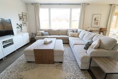 a living room filled with furniture and a flat screen tv