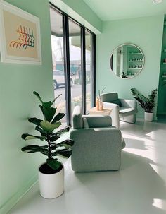 a living room with green walls and white floors