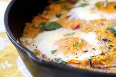 an omelet is in a black pan on a table