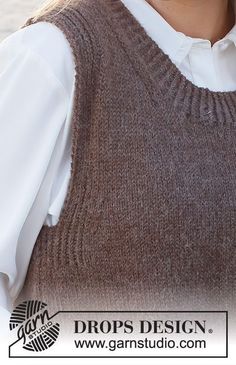 a woman wearing a brown sweater vest and white shirt