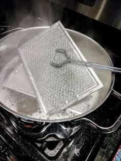 a frying pan sitting on top of an oven with steam coming out of it