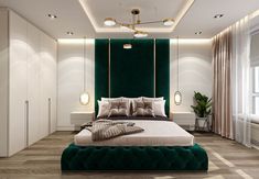 a green and white bedroom with a large bed in the middle, surrounded by tall windows