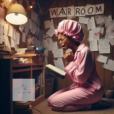 a woman sitting on the floor in front of a desk with papers all over it