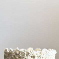 a cake with white frosting and flowers on it