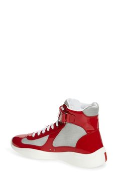 Prada creates a high-top version of its cult sneaker, which was originally designed for the Luna Rossa sailing team to wear during the 2000 America's Cup. It's crafted from a mix of patent leather and breathable mesh with a lightweight, flexible sole sporting the iconic red logo. 5" shaft, 12" circumference (size 7.5) Lace-up style; adjustable ankle strap with hook-and-loop closure Removable insole Textile and leather upper and lining/rubber sole Made in Italy Men's Designer Shoes America's Cup, Logo Style, Americas Cup, Mens Designer Shoes, High Top Sneaker, Sneaker Men, Red Logo, Up Styles, High Top