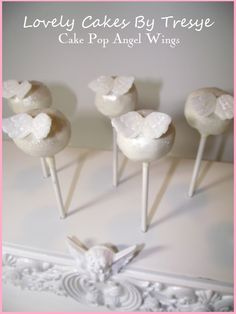 four cake pops with white frosting on them sitting in front of a pink frame