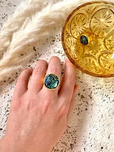 Gold plated, adjustable sized hammered ring with a large circular center made of multi-colored abalone shell pieces on a base of black polymer clay. The setting has a protective high shine resin coating, and ring band has been treated with a protective coating to help prevent tarnishing.  center setting is 2cm Hammered Dome Ring As Gift, Hammered Dome Ring Gift, Gift Dome Ring With Hammered Detail, Black Polymer Clay, Hammered Ring, Gold Cocktail Ring, Trendy Ring, Party Rings, Hammered Gold