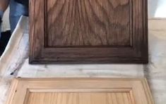 a person standing next to a wooden door on top of a tile floor with an opening in the middle