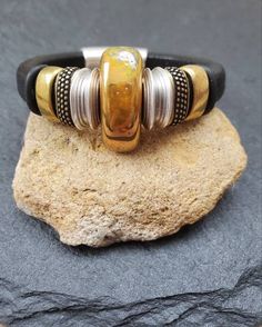 Golden yellow crackled ceramic focal bead enveloped with sterling silver and brass sliders. Genuine black leather measures 10mm x6 mm. Magnetic closure. All bracelet components are lead and nickel free. Brown leather also available. Leather Beaded Bracelet, Yellow Ceramics, Sterling Silver Cuff Bracelet, Bracelet Black, Southwestern Style, Bead Leather, Sterling Silver Cuff, Silver Cuff Bracelet, Focal Bead