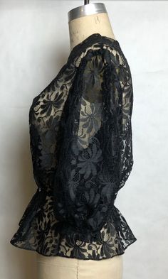 "DETAILS * romantic black lace blouse * puffed half sleeves * rhinestone buttons * elastic waist * completely sheer * perfect for a boudoir photoshoot ERA: 1980s LABEL: n/a SIZE: Medium shoulders: 15\" bust: 36\" (doubled) waist: 26\" sleeve length: 16\" length: 24\" FABRIC: feels like nylon COLOR: black CONDITION: excellent, has been dry cleaned! Please contact us about any questions you may have regarding condition before purchasing. We strive to mention and photograph as many flaws to note ho Black Lace Evening Blouse, Black Lace Blouse For Evening, Vintage Black Blouse With Lace Trim, Black Lace Cuffs Blouse For Evening, Black Evening Blouse With Lace Cuffs, Peach Blouse, Fringe Vest, Black Lace Blouse, White Trim