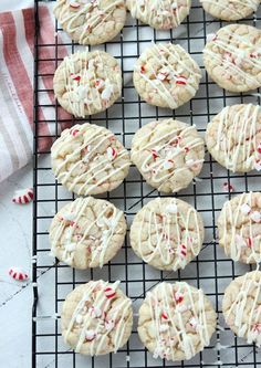 cookies with white icing and sprinkles on a cooling rack