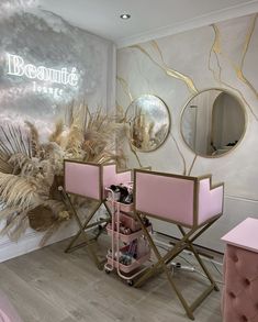 a salon with pink chairs and mirrors on the wall